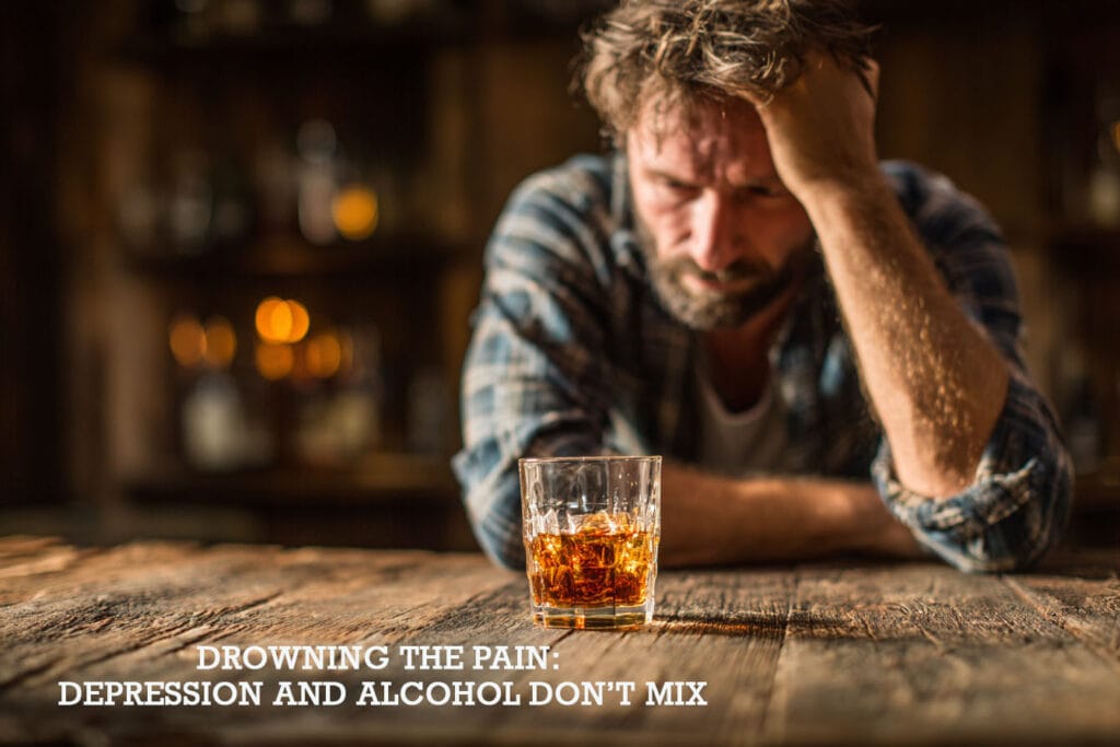 A man sitting alone at a wooden bar, staring at a glass of whisky, symbolising the struggle between depression and alcohol.