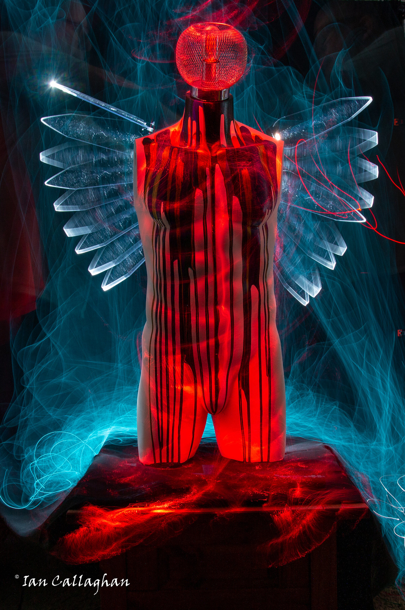 Angel mannequin covered in acrylic pour art