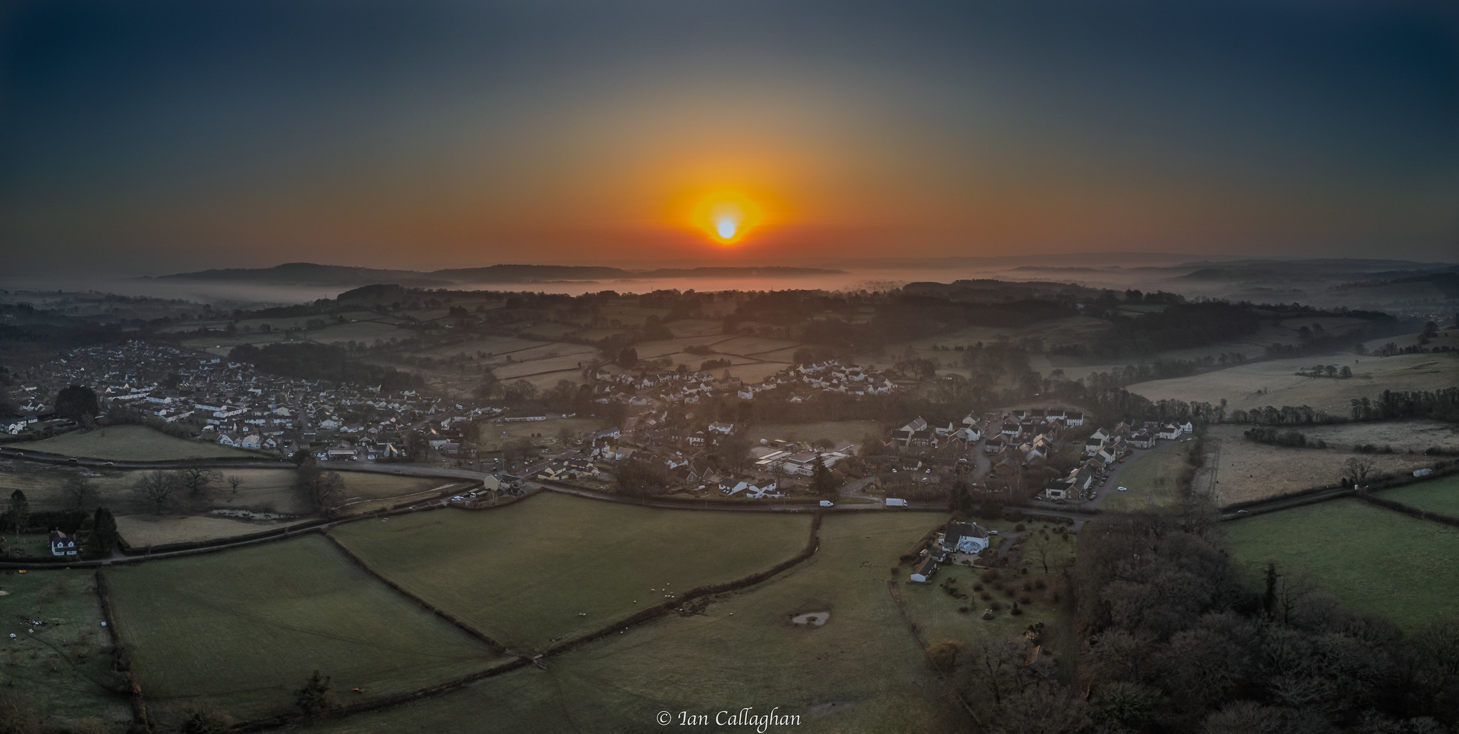 Misty sunrise over water